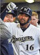  ?? BENNY SIEU / USA TODAY SPORTS ?? Milwaukee’s Domingo Santana is greeted in the dugout after hitting a solo home run in the fourth inning.