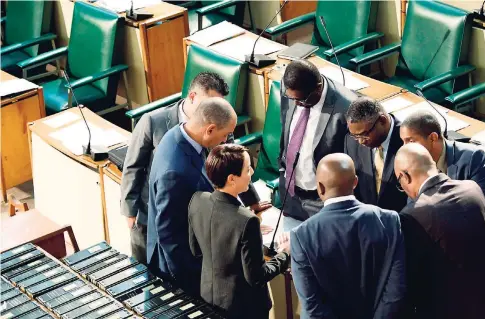  ?? FILE ?? Government lawmakers in the Upper House in discussion before debating the NIDS legislatio­n in Gordon House on November 13, 2017.