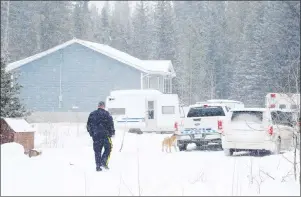  ?? CP PHOTO ?? RCMP attend the scene after an infant was found dead and 14 others were sent to Alberta Children’s Hospital from a home on the Stoney Nakoda First Nation, 80 kilometres west of Calgary, Wednesday.