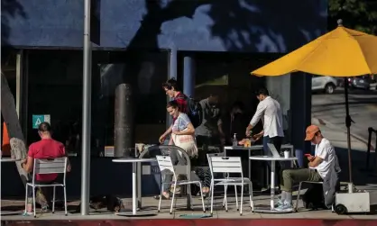  ?? Ferazzi/Los Angeles Times/Rex/Shuttersto­ck ?? Patrons sit at a cafe in West Hollywood. Cafe workers will soon benefit from the increase in the city’s minimum wage. Photograph: Gina