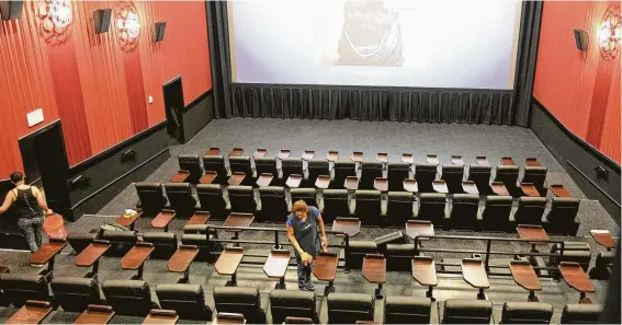  ?? Craig Moseley / Houston Chronicle ?? Workers clean a theater at the Alamo Drafthouse Cinema — LaCenterra during a pre-opening media tour. Theaters can accommodat­e 40-139 patrons.