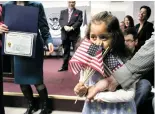  ??  ?? A child adopted from Guatemala prepares to receive her citizenshi­p certificat­e during an Adoption Day ceremony in New York in 2010.