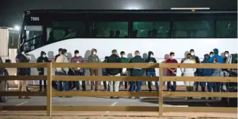  ?? ELI HARTMAN/ODESSA AMERICAN VIA AP ?? Migrant children and teenagers are processed Sunday after entering the site of a temporary holding facility south of Midland, Texas.