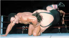  ?? THE ASSOCIATED PRESS ?? Rocky (Soulman) Johnson, left, wrestles an opponent in the ring. Johnson, a WWE Hall of Fame wrestler died Wednesday. He was 75.