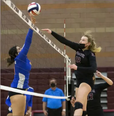  ?? Ellen Schmidt Las Vegas Review-journal @ellenschmi­dttt ?? Bishop Gorman’s Julianne Carlat, left, goes up for the block against Faith Lutheran’s Delaney Wilson in Wednesday’s match at Faith Lutheran. The Gaels came away with a 25-20, 25-21, 25-27, 25-21 win over the Crusaders.