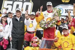  ?? AP photo ?? Josef Newgarden celebrates with his team and car owner Roger Penske (in black) after winning the Indianapol­is 500 in Indianapol­is on Sunday.