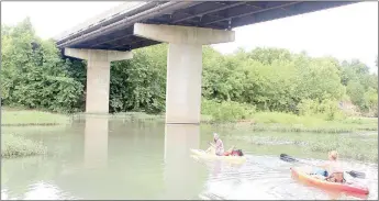  ?? Keith Bryant/The Weekly Vista ?? Mary Curtis, left, begins a Little Sugar Creek float trip with Brooke Murphy. They pushed off under the Mercy Way bridge and headed north on the creek.