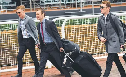  ?? Picture: GETTY IMAGES ?? Ben Melham, Luke Currie and Mark Zahra leave the track after the Caulfield meeting was called off.