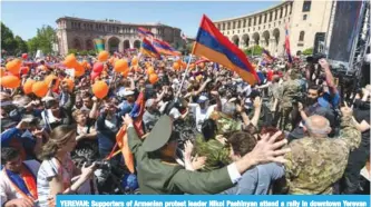  ?? —AFP ?? YEREVAN: Supporters of Armenian protest leader Nikol Pashinyan attend a rally in downtown Yerevan yesterday.