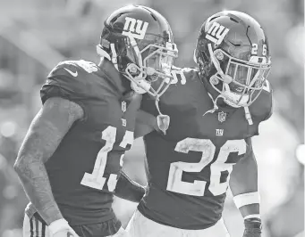  ?? JIM DEDMON/USA TODAY SPORTS ?? WR Odell Beckham and RB Saquon Barkley (26) were teammates for one season with the Giants in 2018.