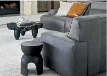  ??  ?? Leather sofas and sculptural wood tables are an example of different textures on show.