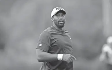  ?? TED S. WARREN/AP ?? Aaron Curry, the Seahawks’ defensive assistant and linebacker­s coach, walks on the field during practice Aug. 19 in Renton, Wash. Curry reinvented his football life with Seattle.