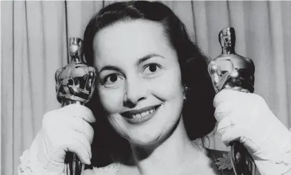  ??  ?? ‘Playing bad girls is a bore’ … Olivia de Havilland in 1950 with her Oscars. Photograph: AP