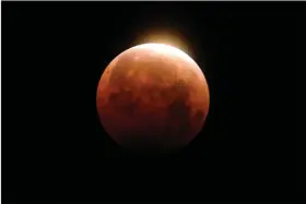  ?? (AP/Ringo H.W. Chiu) ?? Light shines from a total lunar eclipse over Santa Monica Beach in Santa Monica, Calif., on May 26, 2021.