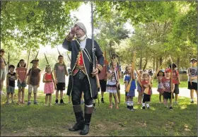  ?? AP/The Free Lance-Star/MIKE MORONES ?? Hector Diaz, portraying Bernardo de Galvez, the Spanish governor of Louisiana, drills children in Revolution­ary War-era tactics at an event Wednesday in Fredericks­burg, Va.