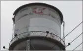  ?? BILL DEBUS — THE NEWS-HERALD ?? A new coat of white paint covers a portion of the Madison water tower viewed Dec. 3 looking south on Route 528 toward I-90, near McDonald’s.