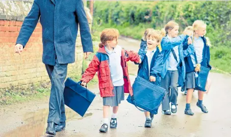  ??  ?? BAGS OF FUN: Children are taking more and more possession­s to school, including some high-cost items
