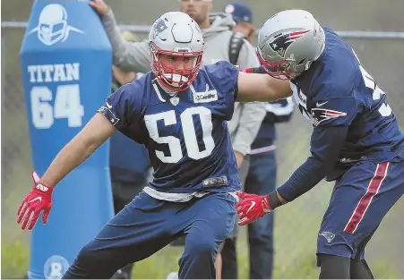  ?? STAFF PHOTOS BY NANCY LANE ?? CARVING OUT HIS SPOT: Rob Ninkovich (50) battles with Trey Flowers during Patriots offseason workouts yesterday at Gillette Stadium; at right, tight end Dwayne Allen loosens up as he tries to make a good impression in his first season with the team.