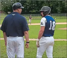  ?? GAVIN KEEFE/DAY PHOTO ?? Steve Barmakian of the Mystic Schooners, right, talks with manager Phil Orbe in the bottom of the first inning during the opening game of a NECBL doublehead­er against the Danbury Westerners on Monday at Fitch High School in Groton.