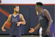  ?? Paul Chinn / The Chronicle ?? Point guard Jordon Ford (left) figures to be the Gaels’ main man, while forward Malik Fitts is competing for a top role.