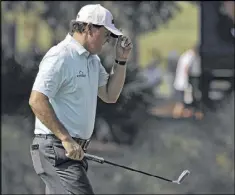  ?? AP ?? Phil Mickelson acknowledg­es cheers after putting out on No. 10 on Thursday. Mickelson opted against playing a practice round at TPC Sawgrass this week.