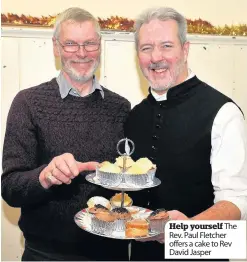  ??  ?? Help yourself The Rev. Paul Fletcher offers a cake to Rev David Jasper