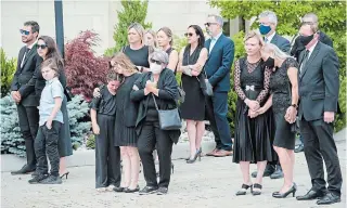  ?? NATHAN DENETTE THE CANADIAN PRESS ?? Family members react as they watch the arrival of the caskets of Karolina Ciasullo and her three young daughters, killed in a car crash, at their funeral service in Brampton, Ont., on Thursday.