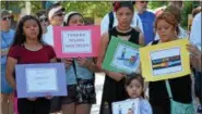  ?? MARIAN DENNIS – DIGITAL FIRST MEDIA ?? A family stands together outside the Montgomery County Courthouse Saturday during the Families Belong Together rally. The rally was one of many held Saturday all over the country.