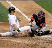  ?? AP PHOTO BY JED JACOBSOHN ?? Oakland Athletics’ Sean Murphy is tagged out at home by Houston Astros’ Martin Maldonado during the seventh inning of the first baseball game of a doublehead­er in Oakland, Calif., Tuesday, Sept. 8.