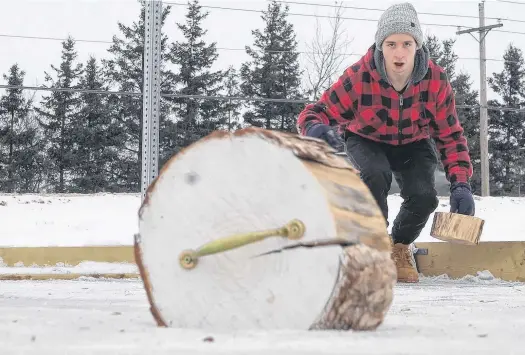  ?? DANIEL BROWN • LOCAL JOURNALISM INITIATIVE REPORTER ?? Eli Grant watches in anticipati­on just as his crokicurl rock slides into the centre of the crokicurl rink in Cornwall.