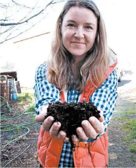  ?? HOPE WELL VINEYARDS ?? Winemaker Mimi Casteel with compost she uses to build a healthy habitat for microorgan­isms and robust topsoil at her vineyard in Oregon’s Willamette Valley.