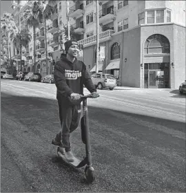  ?? Steve Lopez Los Angeles Times ?? L.A. CITY Controller-elect Kenneth Mejia uses a scooter to get to his downtown campaign office. He says he does regret some of his past words and actions.