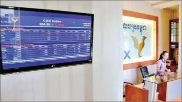  ?? HENG CHIVOAN ?? A monitor displays stock informatio­n next to the reception of the Cambodia Securities Exchange.