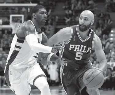  ?? Associated Press ?? n Philadelph­ia 76ers' Kendall Marshall (5) drives against Milwaukee Bucks' O.J. Mayo during an NBA basketball game Dec. 25, 2015, in Milwaukee. The jerseys say U.S.A., though that's about all that will be recognizab­le. The Americans are cautiously...