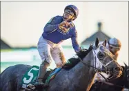  ?? Bobby Ellis / TNS ?? Jockey Luis Saez celebrates aboard Essential Quality after winning the Breeders Cup Juvenile on Nov. 6. The colt is the Kentucky Derby favorite and drew the No. 14 post Tuesday.