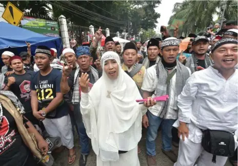  ?? ADEK BERRY/AFP/GETTY IMAGES ?? Indonesian Muslim supporters chant after a trial in Jakarta. Its Christian governor was given two years in prison after being found guilty of blasphemy.