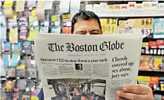  ??  ?? Phillip Minias, 46, owner of Snax Express, reads the Boston Globe in Boston, Massachuse­tts. — AFP photo