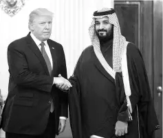  ?? — AFP photo ?? Trump and Mohammed shake hands at the White House in this file photo.