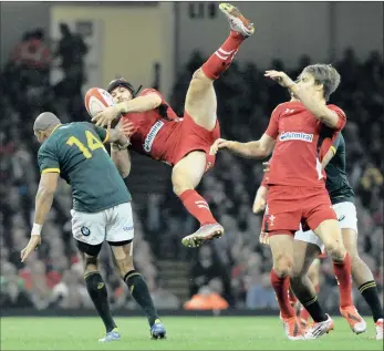  ?? Picture: AP PHOTO/ RUI VIEIRA ?? TURNING POINT: Wales’s Leigh Halfpenny, centre, is tackled by South Africa’s Cornal Hendricks during the Test between Wales and South Africa at the Millennium Stadium in Cardiff, last night.