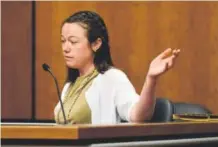  ?? Matthew Jonas, Longmont Times-Call ?? Michelle Wilkins points to a photo of her unborn child, whom she planned to name Aurora, during the sentencing of Lane.