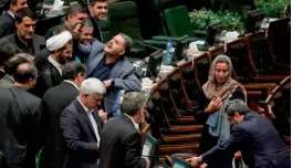  ?? — AFP ?? An Iranian MP takes a selfie as EU foreign policy chief Federica Mogherini walks by at the ceremony for the swearing-in of Iran’s President in Parliament in Tehran.