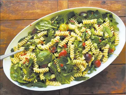  ?? The Associated Press ?? In this pasta salad, the asparagus and sugar snap peas get a bit more tender after a quick simmer and chill.