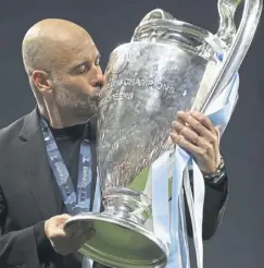  ?? ?? Manchester City manager Pep Guardiola kisses the Champions League trophy after his team’s victory over Inter Milan last June