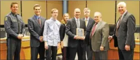  ?? SUBMITTED PHOTO — COURTESY OF MONTGOMERY TOWNSHIP ?? Retiring Montgomery Township police Sgt. Dan Mitchell, center, poses with family members, Montgomery Township’s supervisor­s and police Chief Scott Bendig after being recognized by the board Monday night.