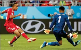  ??  ?? BOY DANE GOOD: Poulsen keeps his calm to slot past Peru goalie Pedro Gallese