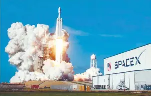  ?? REUTERSPIX ?? ... The SpaceX Falcon Heavy launches from Pad 39A at the Kennedy Space Centre in Florida, on Tuesday on its highly anticipate­d maiden test flight. The world’s most powerful rocket is carrying CEO Elon Musk’s cherry red Tesla roadster to an orbit near...