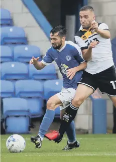  ??  ?? Gwion Edwards is tackled by Port Vale’s Martin Paterson.