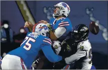  ?? JEFFREY T. BARNES — THE ASSOCIATED PRESS ?? Baltimore linebacker Matt Judon, right, hits Buffalo quarterbac­k Josh Allen, center, forcing a fumble during the first half of Saturday night’s playoff game in Orchard Park, N.Y. The Bills recovered the ball. The BillsRaven­s game was still in progress when this edition went to press. Go to
stats.mercurynew­s.com/gamematchu­ps for game details and a box score.