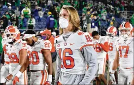  ?? MATT CASHORE/ POOL PHOTOVIA AP ?? Clemson quarterbac­k Trevor Lawrence, whowas unable to play, leaves the field after a 47- 40 overtime loss toNotre Dameon Saturday night.