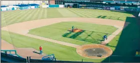  ?? AP/PAT EATON-ROBB ?? Grounds crews prepare the field March 30 at Dunkin Donuts Park in Hartford, Conn. The baseball stadium is used by the Double-A affiliate of the Colorado Rockies.